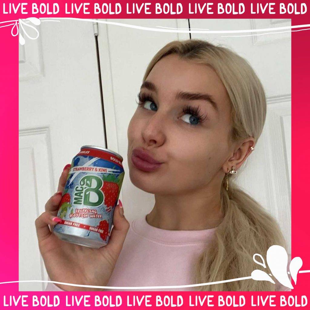 abigail comrie with a can of macb sparkling flavoured spring water strawberry & kiwi flavour