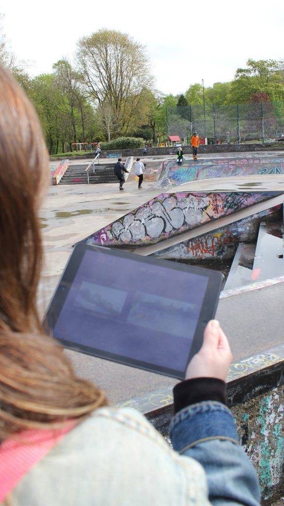 Woman looking at ipad behind the scenes tv ad filming