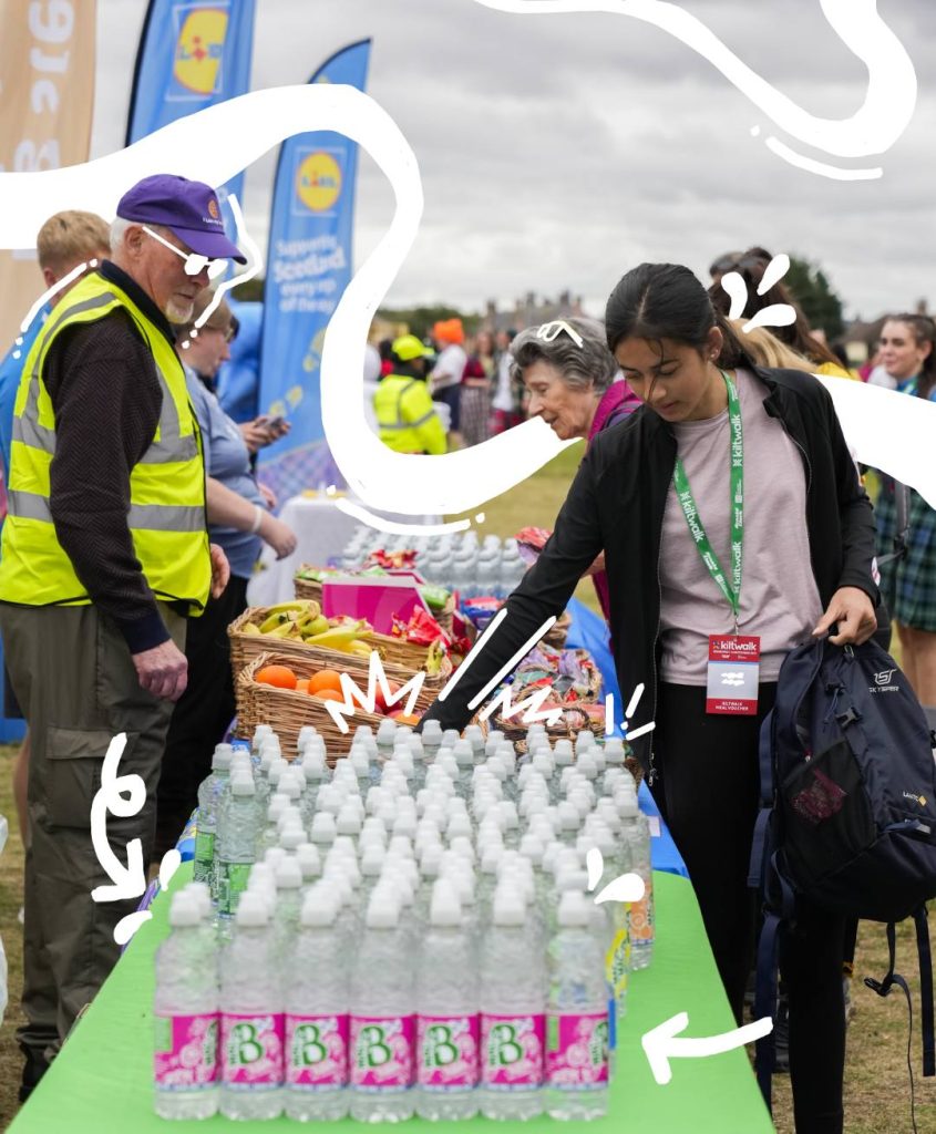 macb staff members in front of a kiltwalk water station stocked with macb water